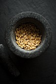Pine nuts in a mortar (seen from above)