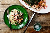 Oven-baked salmon with a herb crust, couscous and pomegranate seeds