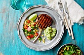 Grilled pork chop with salad and guacamole (Mexico)