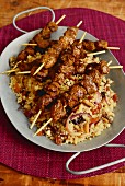 Lamb skewers on a bed of couscous with dried fruit and pine nuts (Arabia)