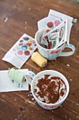 Cress seeds on cotton wool in a cup next to craft utensils and decorations