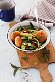 Prawn cakes with an avocado and cucumber salad
