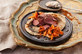 Fried lamb fillets with a carrot salad and hummus