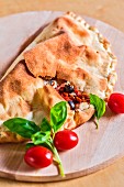 Calzone caprese (pizza pocket with tomatoes and mozzarella, Italy)