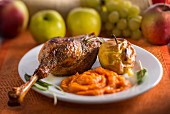 Goose leg with pumpkin puree and a baked apple