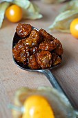 Dried physalis on a spoon (close-up)