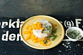 Coconut and semolina pudding with mango compote and mint sugar