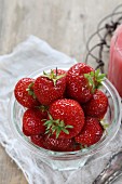 Fresh strawberries in a jar with a homemade strawberry milkshake