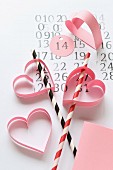 Craft idea for Valentine's Day: hand-crafted, paper love-hearts decorating drinking straws