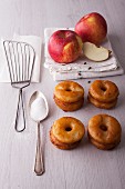 Apple doughnuts, sugar and fresh apples