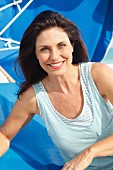 A brunette woman on a beach wearing a light-blue, 2-in-1 top