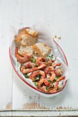 King prawns with serrano ham, herbs and baguette