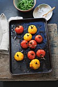 Oven-roasted red and yellow tomatoes on a baking tray