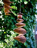 Wooden spiral mobile hanging in garden