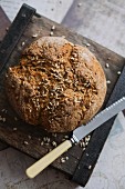 Irish soda bread with sunflower seeds and a knife