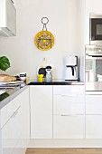 Detail of modern, white fitted kitchen