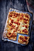 A sliced cheese and tomato tray bake pizza