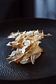 Quail poached in salt water with parsnip chips, egg and flower petals in 'Quay', Sydney