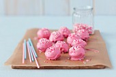 Pink cake pops on a piece of baking paper