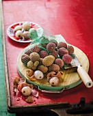 Shelled and unshelled lychees on a wooden board