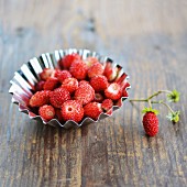 Fresh wild strawberries in a metal baking tin