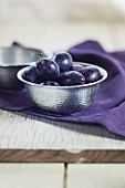 Plums in a metal bowl