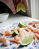 Prawns being drizzled with lime juice
