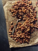 Spicy peanuts on a piece of baking paper (seen from above)