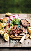 Grilled, marinated beef steaks with garlic bread
