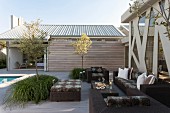 Modern, dark wicker outdoor furniture on spacious terrace