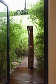 Sculptural fountain on boardwalk in bamboo garden