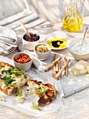 Various dips, grissini, pizza bread and Parmesan (Italy)