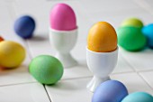 Coloured Easter eggs in egg cups