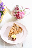 A slice of apple cake with a rose