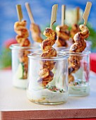 Chicken skewers with a dip in glasses