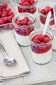 Sweetened goat's cream cheese with raspberries in glasses on a tray