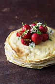 A stack of crepes with fresh strawberries