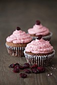 Chocolate cupcakes with a cranberry topping, pink sugar pearls and dried cranberries
