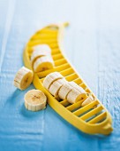 A yellow banana slices on a blue surface