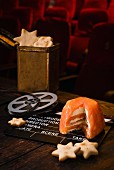 Smoked salmon terrine with star crackers and film decorations in a cinema