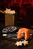 Smoked salmon terrine with star-shaped crackers and a film-themed decorations in a cinema