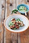 Tofu and apple skewers on mashed peas and potatoes