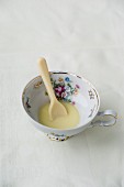 A white chocolate spoon dissolving in hot milk