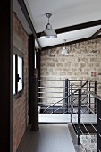 Gallery with stainless steel and steel rope balustrade in loft apartment