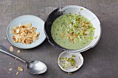 Vegetarian herb soup with white asparagus and flaked almonds