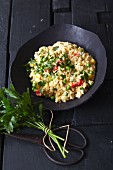 Vegetarian millet risotto with peppers, peas, ajvar and parsley