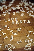 The words Love and Pasta spelt with alphabet pasta