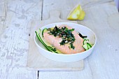 Poached salmon fillet with herbs and capers