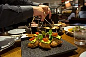 Chicken breast skewers with courgettes and cherry tomatoes in a restaurant