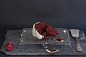 A slice of Red Velvet cake on a wire rack
